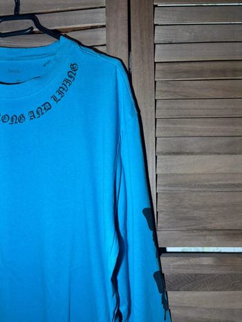 Haut bleu longues manches avec papillon noirs Bershka Taille L / 40