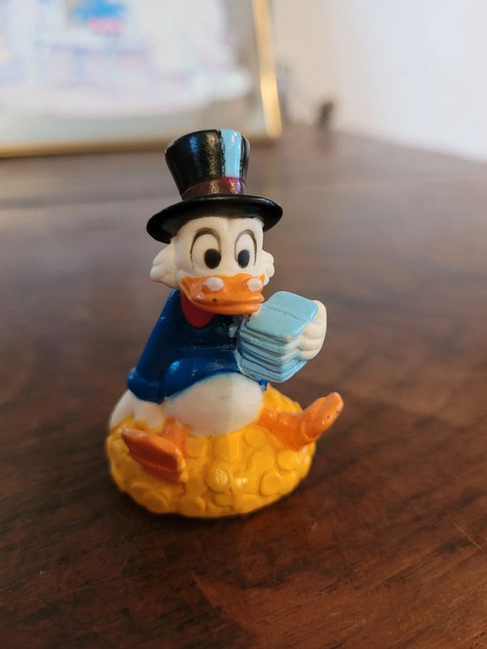 Vends figurine picsou assis sur son or 70s