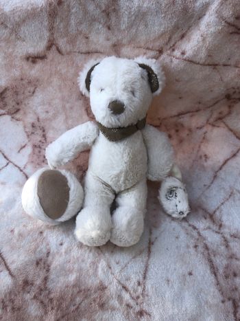 Doudou peluche ours blanc marron grelot ballon Nicotoy