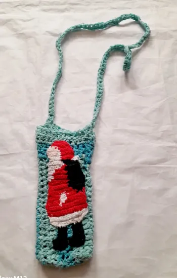 Sac pour smartphone de Noël fait main au crochet bleu avec un Père Noël