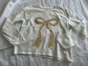 Haut blanc noeud sequin doré