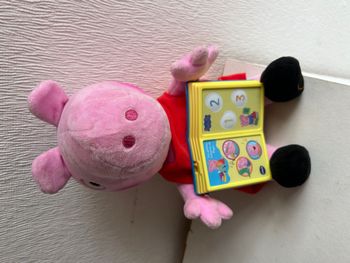 peluche peppa pig qui lit des histoires