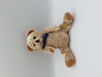 Peluche doudou ours beige marron LBP Magnet Atlantis nœud bleu 16 cm assis