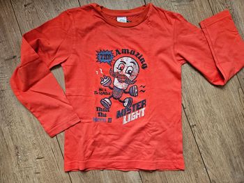 T.shirt manches longues orange à motifs 6 ans