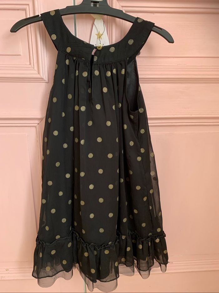 Très jolie robe noire à pois dorés 8 ans tbe
