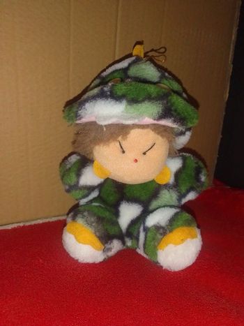 Peluche "Garçon déguisé en bébé dinosaure