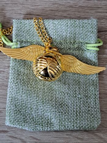 Montre pendentif Harry Potter Vif d' or vendue avec une pochette