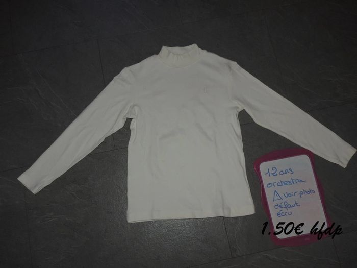 sous pull orchestra taille 12 ans ATTENtion la colle de l'étiquette est resté marqué voir photo