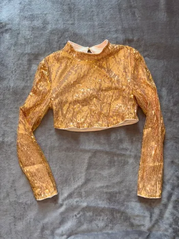 Haut femme à paillettes court à manches longues Shein en très bon état taille 34. Couleur doré.