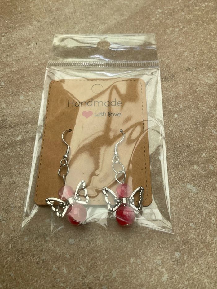 Boucles d’oreilles ange rouge neuve