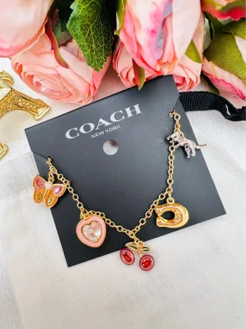 🦖Bracelet charms doré Coach New York – Papillon, cœur, cerises, logo C doré, dinosaure