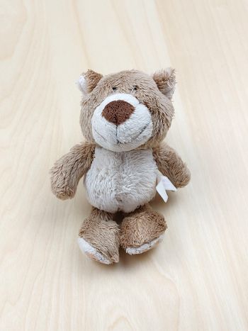 Petite peluche doudou ours marron ventre beige NICI 14 cm empreintes roses