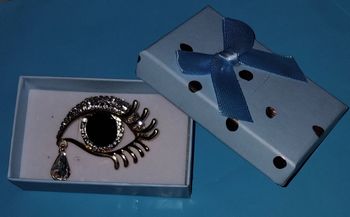 Broche fantaisie forme œil noir - strass - doré