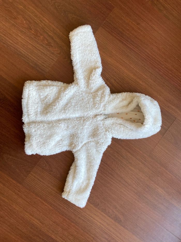 Veste fausse fourrure blanche à paillettes