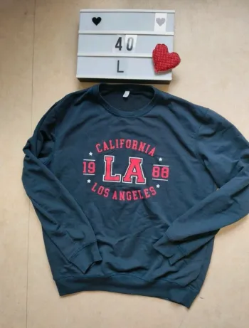 Sweat bleu coupe large avec inscription devant taille 40/L tex