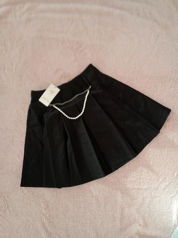 Jupe plissée noire avec bijou