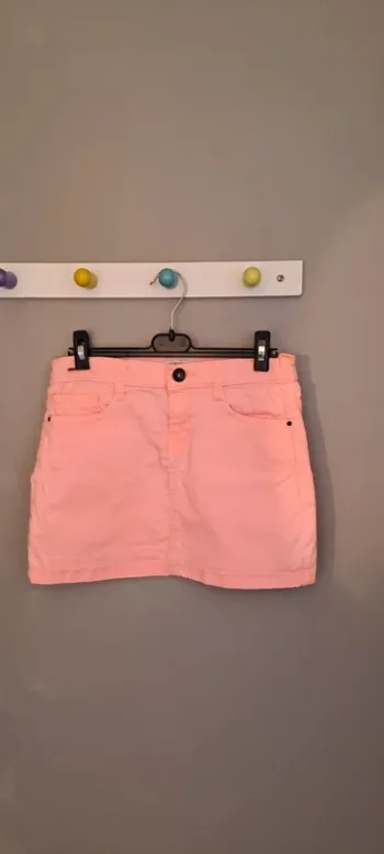 Jupe courte orangée - Marque Vitamine - Taille 12 ans - Très bon état.