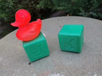 Lot de jouets en plastique canard rouge et deux cubes verts avec des lettres