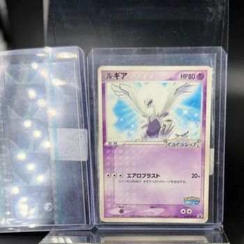Lot d'une carte Pokémon Lugia japonaise promo 038/PCG-P état played donc abîmée + une diapositive de Lugia en bon état
