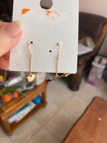 Boucles d’oreilles cœur et flèche dorés.