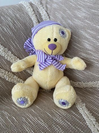 Peluche doudou 28cm ours jaune à fleur violette marguerite très bon état