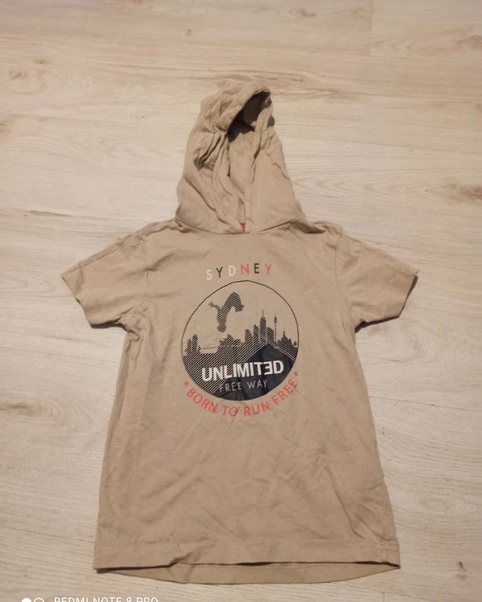 Tee shirt a capuche beige taille 5/6 ans.