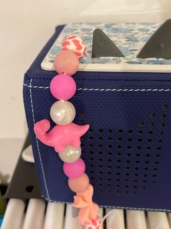 Cache poussière dino rose