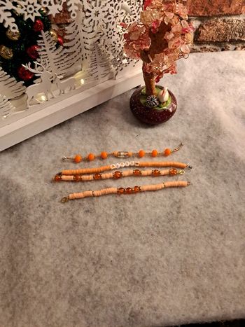 Lot de bracelets orange et doré heishie