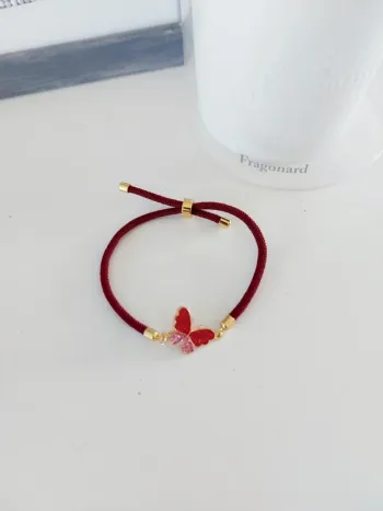 Bracelet tissu ajustable breloque papillon