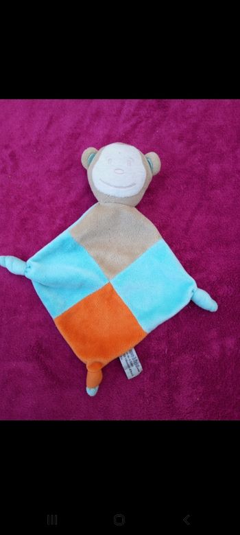 Doudou singe avec nœuds dans les coins