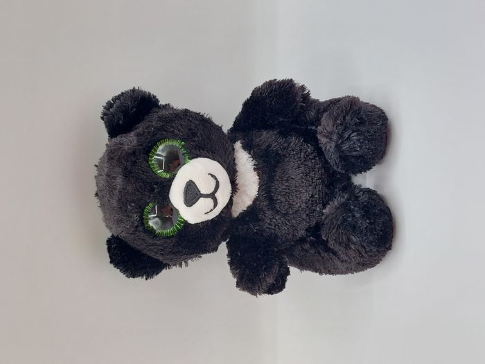 Peluche doudou ours noir blanc B&G International gros yeux verts 14 cm