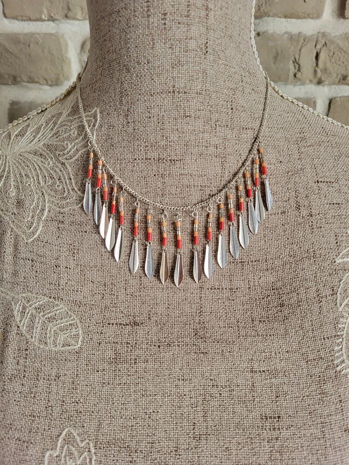 Collier argenté perles ton orange corail et
plumes