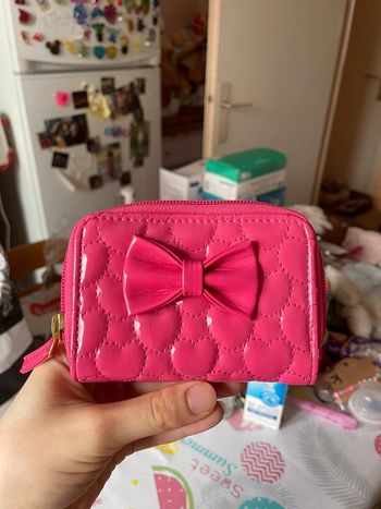 Porte monnaie rose avec noeud.