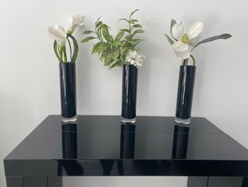 Vases en verre noirs avec fleurs incluses