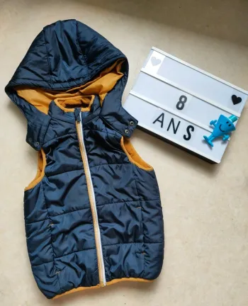 Doudoune sans manches à capuche et poches 8 ans orchestra