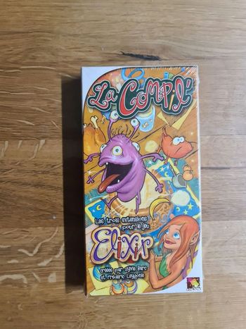 Neuf sous cellophane jeu de société Elixir La Compil des éditions Asmodée
