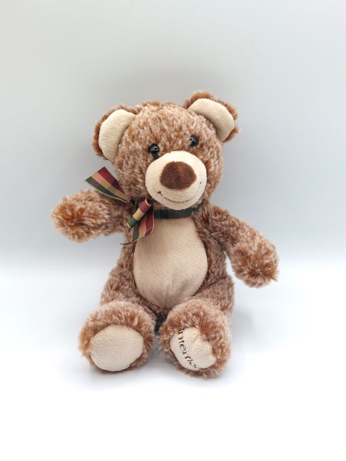 Peluche doudou ours marron chiné beige INTERFLORA Famosa 2019 20 cm nœud carreaux état neuf