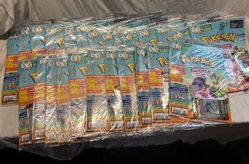 25 magazines pokemon + 50 boosters