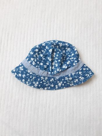 Chapeau bleu à fleurs blanches