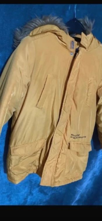 Manteaux jaunes moutarde recousu en dessous bas taille 10 ans