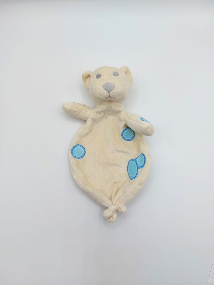 Doudou plat ours écru crème DECAROLI COSFIBEL rond bleu yeux gris