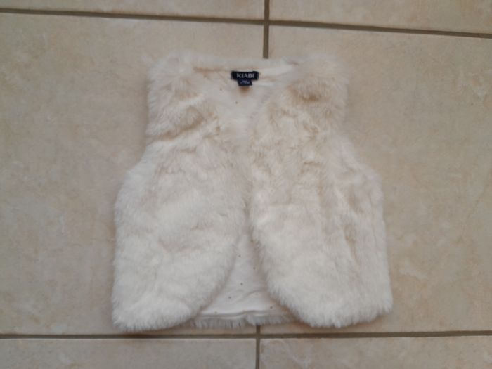 Boléro/gilet sans manches fausse fourrure blanche