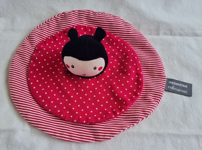 Doudou rond plat rouge rose - Coccinelle- Orchestra