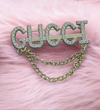 Broche or doré Gucci