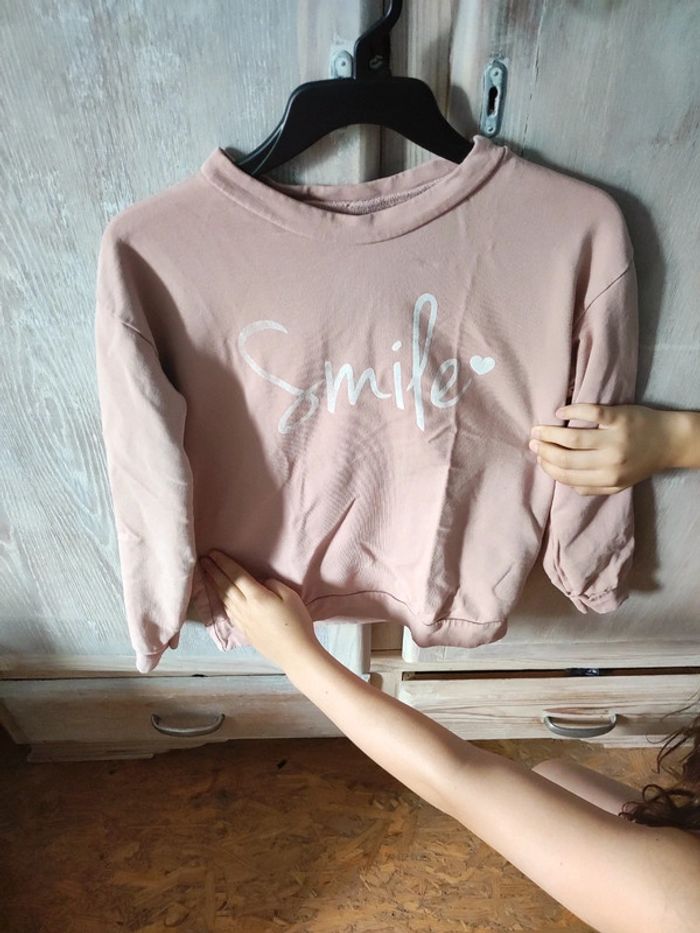 Pull rose avec motif smiley blanc