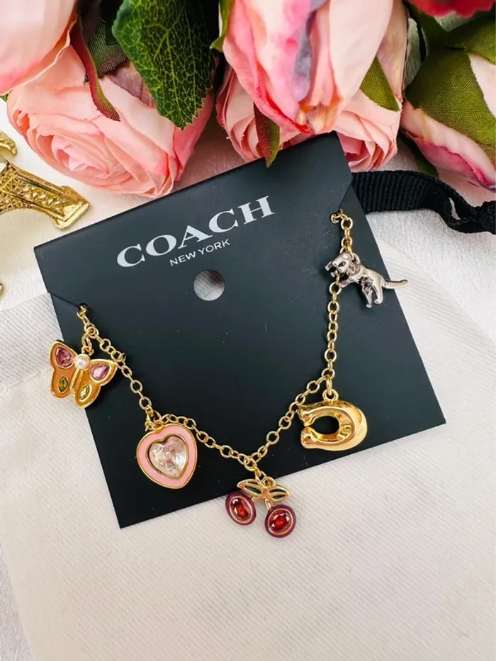 🦖Bracelet charms doré Coach New York – Papillon, cœur, cerises, logo C doré, dinosaure - photo numéro 7