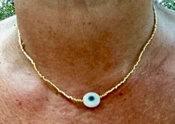 Collier réglable perles dorées œil bleu finition s acier inoxydable or