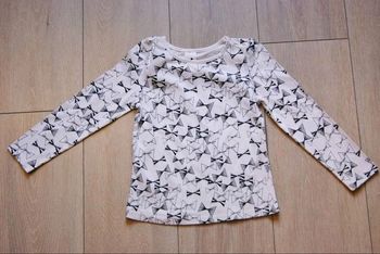 Maillot blanc à motif noeud papillon. 6 ans fille. Marque Palomino