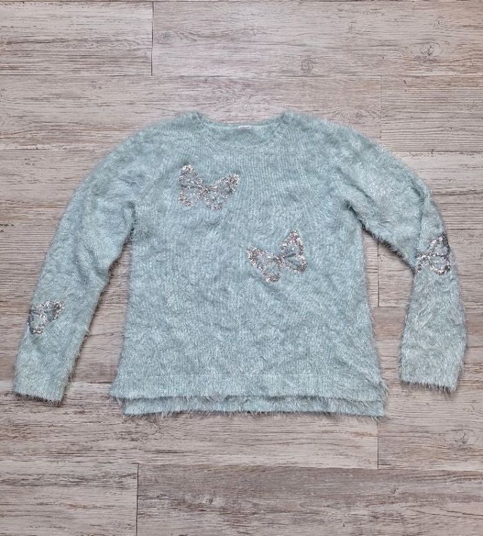 Pull turquoise papillons
