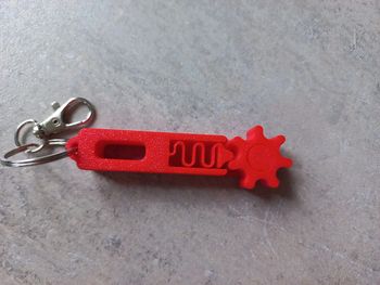 Porte clés engrenages rouge neuf